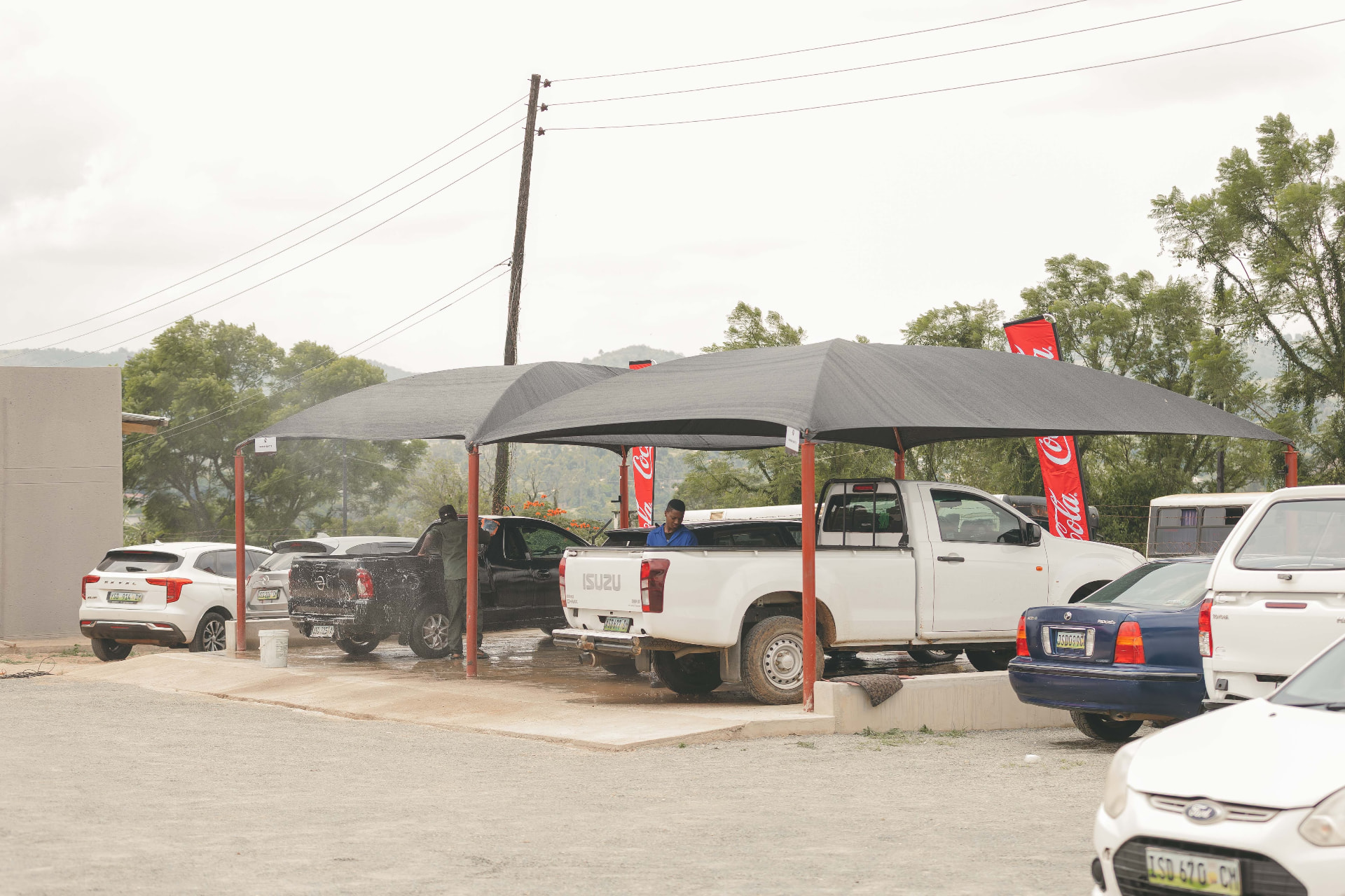 Cars under the shade canopies at MAPS Village Ngwane Park